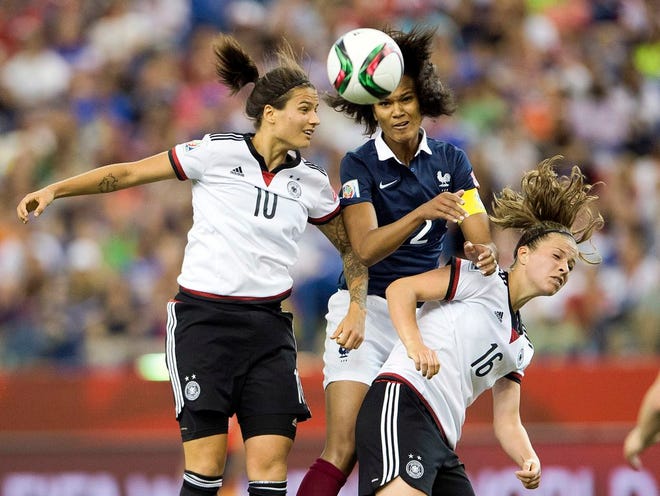 Germany's Dzsenifer Marozsan, left, and Melanie Leupolz, right, battle with France's Wendie Renard during the second half of a quarterfinal match in the FIFA Women's World Cup soccer tournament, Friday, June 26, 2015, in Montreal, Canada.