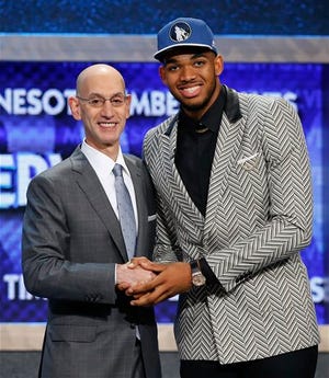 Karl-Anthony Towns, right, poses for a photo with NBA Commissioner Adam Silver after being announced as the top pick during the NBA basketball draft by the Minnesota Timberwolves, Thursday, June 25, 2015, in New York.