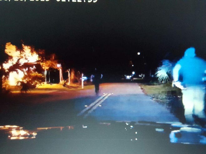 This image from an on-dash video camera shows Gainesville Police Department officers rushing to a house fire Thursday night.