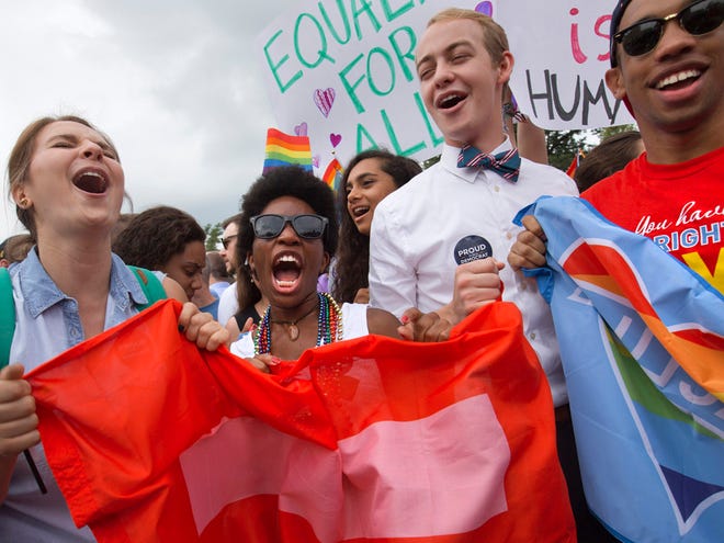 From left, Annie Katz of the University of Michigan, Zaria Cummings of Michigan State University, Spencer Perry of Berkeley, Calif., and Justin Maffett of Dartmouth University, celebrate outside of the Supreme Court in Washington Friday after the court declared that same-sex couples have a right to marry anywhere in the US.
