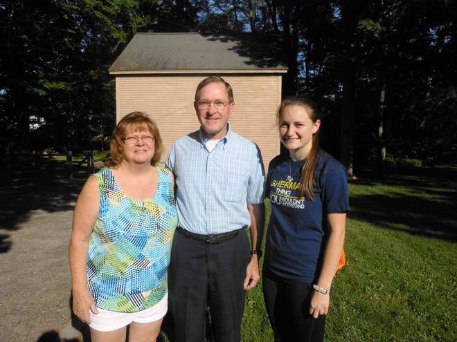 Jefferson Woodson Sherman (center) stands with his wife Debbie and 20 year-old daughter Jaclyn outside the Hancock-Clarke House June 20 as they start out on a march to Boston.

Wicked Local Photo/Erin Lee