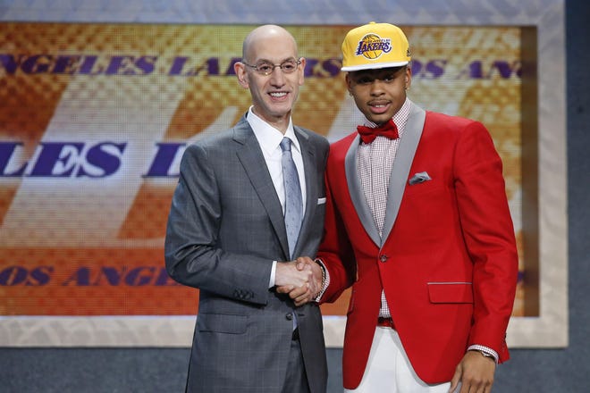 D'Angelo Russell, right, poses for a photo with NBA Commissioner Adam Silver after the Los Angeles Lakers selected Russell with the second pick during the NBA basketball draft, Thursday, June 25, 2015, in New York. (AP Photo/Kathy Willens)