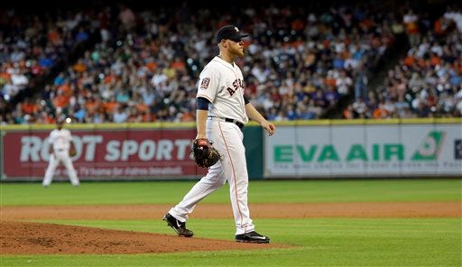 Houston Astros starting pitcher Brett Oberholtzer walks toward the dugout after being ejected from the game by home plate umpire Rob Drake during the second inning of a baseball game against the New York Yankees Saturday, June 27, 2015, in Houston. (AP Photo/David J. Phillip)