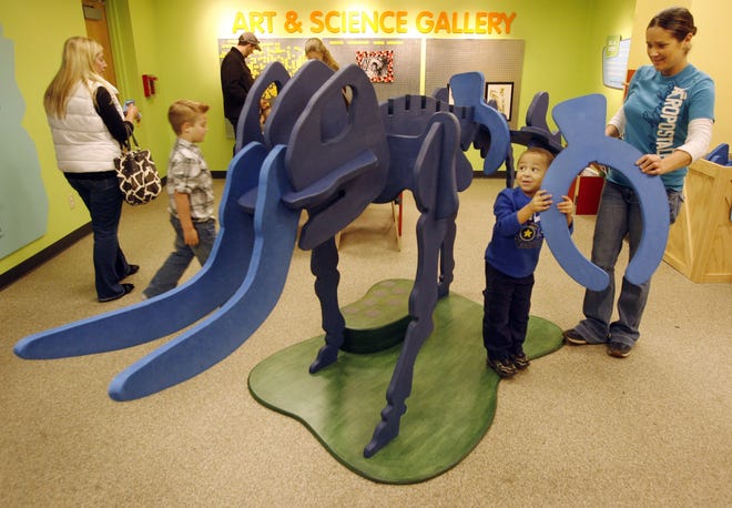 In this 2012 file photo, Isaiah Nickey, 3, adds a bone to the Build-a-Beast mastodon display with help from his mom, Rachelle, at the Illinois State Museum in Springfield. File/The State Journal-Register