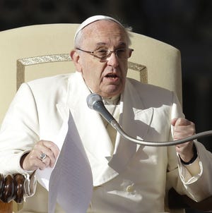 Pope Francis addresses the public during his weekly general audience at the Vatican in Rome.