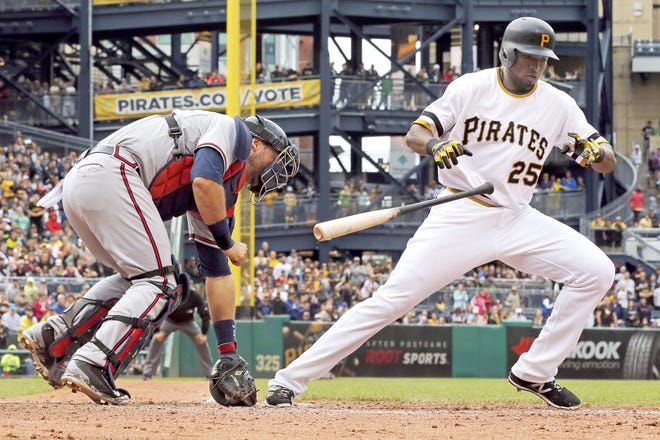 Braves catcher A.J. Pierzynski, left, picks up the ball in front of home plate as Pirates outfielder Gregory Polanco (25) breaks for first base in the ninth inning of Sunday's game in Pittsburgh. Pierzynski threw to first for the final out of a 2-1 Braves win.