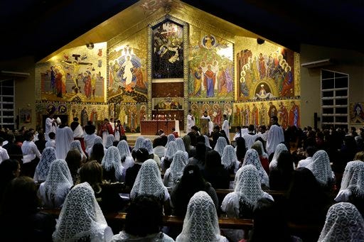 In this May 14, 2015 photo, girls wearing heads veils participate in a confirmation ceremony at the Espiritu Santo Catholic Church in Ciudad del Este, Paraguay. As Paraguayan Catholics prepare to welcome Pope Francis during his South American tour that starts July 5, new leaders of the diocese in this eastern border city are trying to erase the debt left by ousted controversial bishop, the Rev. Rogelio Livieres Plano. (AP Photo/Jorge Saenz)