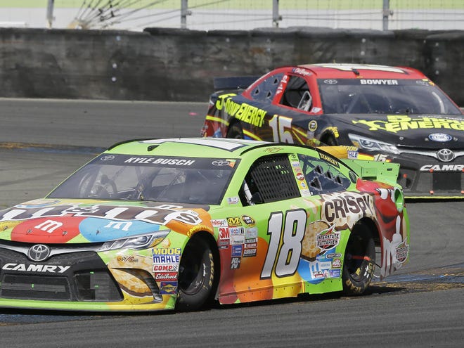 Kyle Busch (18) leads Clint Bowyer through Turn 11 during the NASCAR Sprint Cup Series auto race Sunday in Sonoma, Calif. Busch won the race and Bowyer took third place.