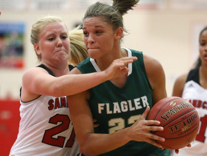 Flagler Palm Coast 's Tamara Henshaw (23) attempts to drive around Seabreeze's Taylor Lee in a game Nov. 10, 2014.