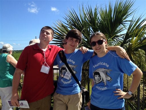 In this photo provided by Kellye Voigt, from left, Gabe Voigt, Joe Garvey and Rachel Lindbergh pose for a photo outside the Kennedy Space Center Visitor Complex in Cape Canaveral, Fla., Sunday, June 28, 2015. The students had a science experiment aboard a SpaceX rocket to the International Space Station that broke apart shortly after liftoff. It was the second time they had lost their experiment in a rocket failure. (Kellye Voigt via AP)