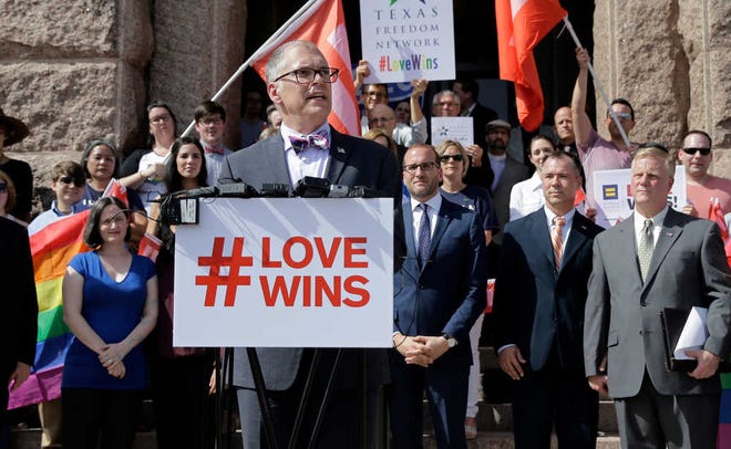 Jim Obergefell, the named plaintiff in the Obergefell v. Hodges Supreme Court case that legalized same-sex marriage nationwide, is backed by supporters of the courts ruling on same-sex marriage on the step of the Texas Capitol during a rally Monday, June 29, in Austin. The Supreme Court declared Friday that same-sex couples have a right to marry anywhere in the United States.