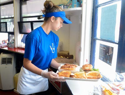Amanda Geilel prepares a tray for a customer's order at Voss on Thursday, June 25, 2015.