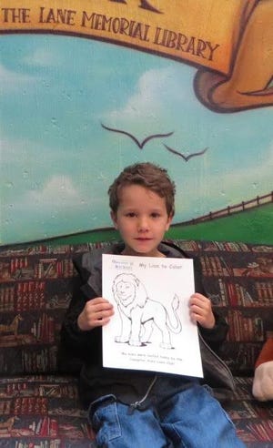 William Lewis shows off his Lions Club coloring page after completing his vision screening at the Lane Memorial Library in Hampton. Courtesy photo