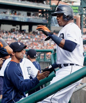 Detroit Tigers' Yoenis Cespedes, right, is congratulated by manager Brad Ausmus after scoring against the Cleveland Indians on a double by J.D. Martinez during the third inning of a baseball game Saturday, June 13, 2015, in Detroit. The Indians defeated the Tigers 5-4. (AP Photo/Duane Burleson)