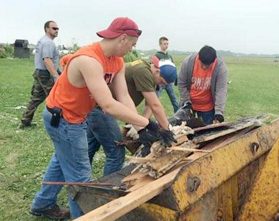 Volunteers picked up all kinds of debris during a Coal City relief effort on Friday with 25 staff and students from Pontiac Township High School.