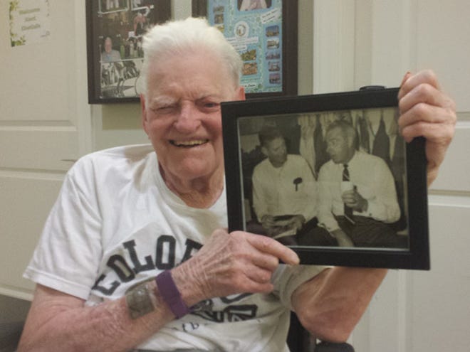 Kent Chetlain, 88, holds a photo of himself interviewing Joe DiMaggio in 1968 at McKechnie Field in Bradenton. Chetlain is a three-time Manatee County Commissioner and longtime newspaper editor who is battling an early form of Alzheimer's.