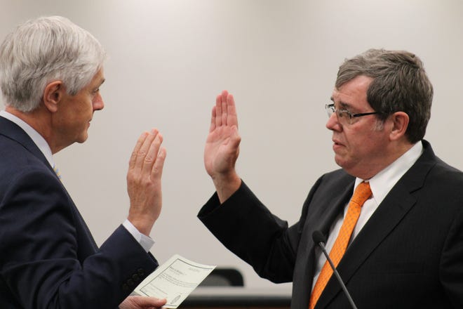 Holland Mayor Bob Vande Vusse, right, is sworn in Wednesday, July 1, by Holland City Clerk Tim Vagle. Andrea Goodell/Sentinel Staff