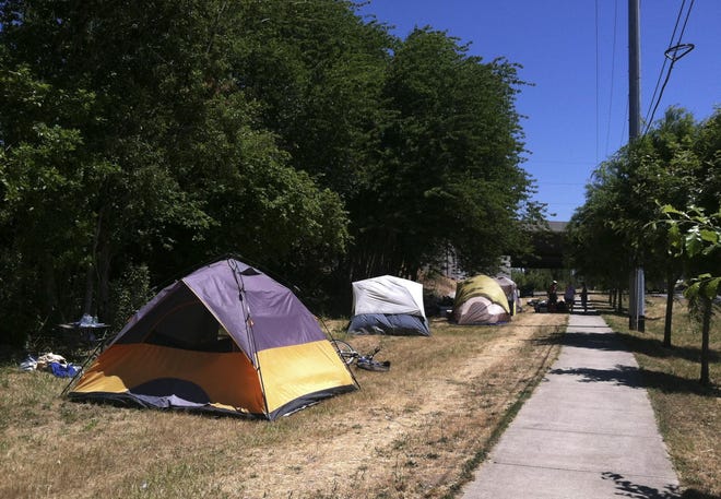 Tents make up a small camp of homeless people along Game Farm Road. (Francesca Fontana/The Register-Guard)
