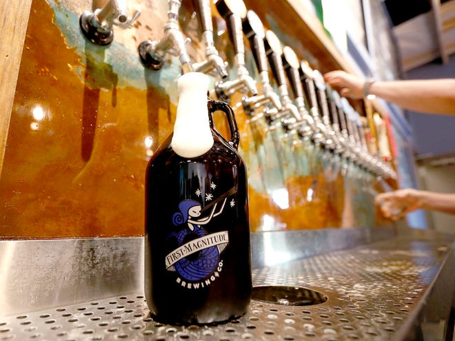 A 64 ounce growler is filled at First Magnitude Brewing in Gainesville on Wednesday.
