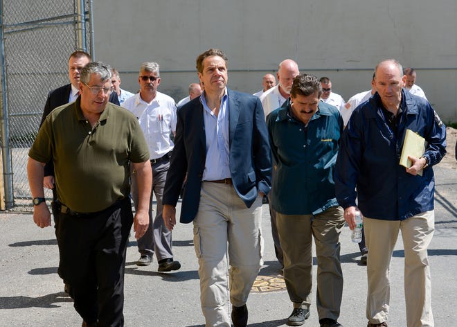 This June 6, 2015 photo provided by New York Gov. Andrew Cuomo's office shows Cuomo, second from left, walking with Steven Racette, left, superintendent of Clinton Correctional Facility, in Dannemora, N.Y. Racette and his deputy in charge of security are among 12 more staff who have been put on administrative leave during the investigation into David Sweat and Richard Matt's escape from the maxiumum-security facility, officials said Tuesday, June 30, 2015. (Darren McGee/Officer of the New York Governor via AP)