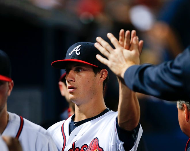Atlanta Braves starting pitcher Matt Wisler (37) is greeted in the dugout after being pulled in the sixth inning of a baseball game against the Washington NationalsWednesday, July 1, 2015, in Atlanta. (AP Photo/John Bazemore)