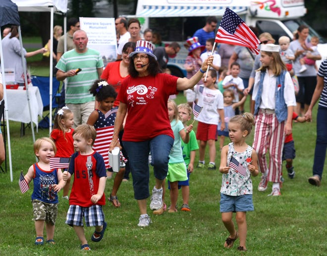 Marilyn Schwartz, director of Kids' Music Round, led children in a patriotic parade at the Lower Makefield Farmers' Market on Thursday, July 2, 2015.