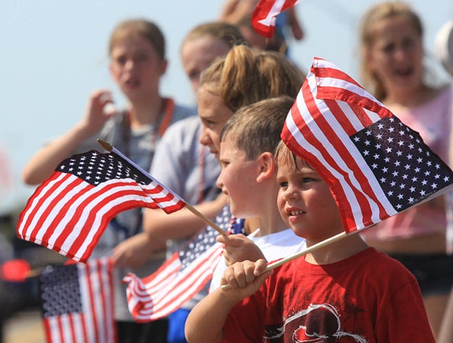 Children wait for candy from the parade floats during an Independence Day parade in Flagler Beach.