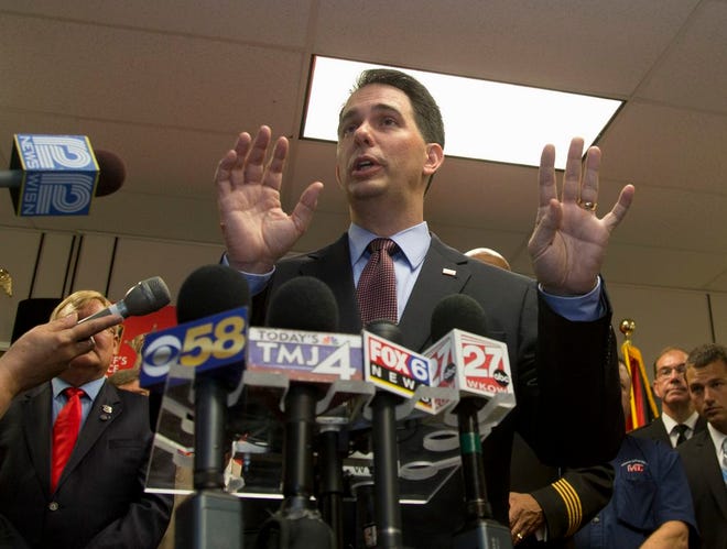 In this June 24, 2015 file photo, Wisconsin Governor Scott Walker speaks in Milwaukee. Aides to Walker say the Republican is entering the crowded Republican race for president. They say Walkers plans to launch his long-expected run by filing the necessary paperwork Thursday. Walker's official kickoff is expected July 13 in Waukesha, Wisconsin. (AP Photo/Jeffrey Phelps, File)