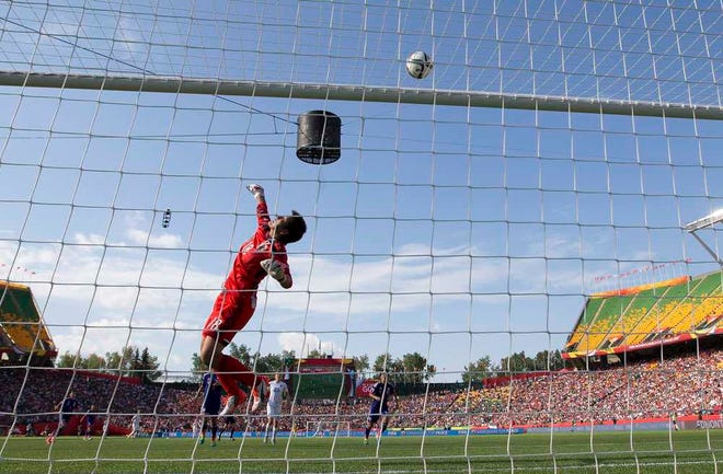 Japan goalkeeper Ayumi Kaihori (18) makes a save against England during the second half of a semifinal in the FIFA Women's World Cup soccer tournament, Wednesday, July 1, 2015, in Edmonton, Alberta, Canada. Japan won 2-1. (Jason Franson/The Canadian Press via AP)