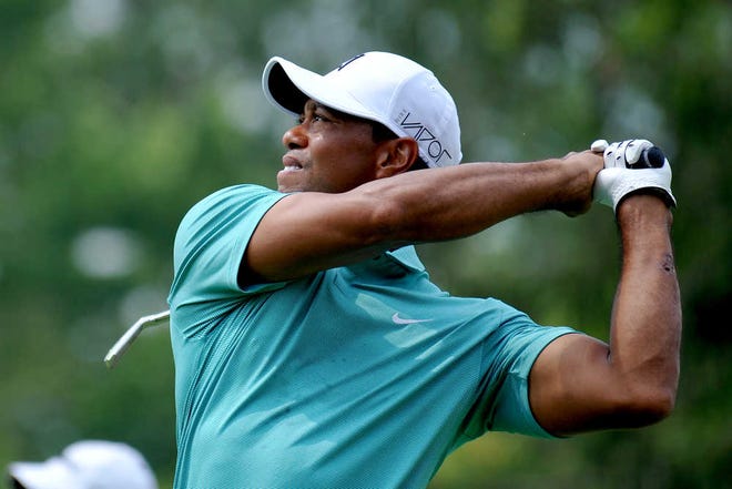 Tiger Woods tees off on the fourth hole during the first round of the Greenbrier Classic at the Greenbrier Resort on Thursday in White Sulphur Springs, W.Va. (AP Photo/Chris Tilley)