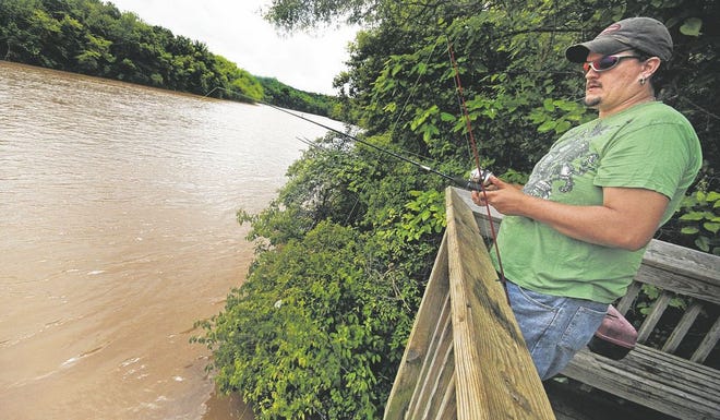 Justin Williams fishes at the Broad River Greenway pier in 2012.