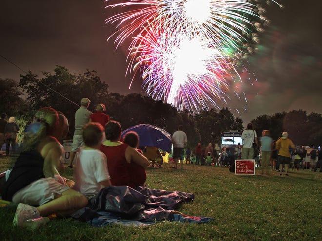 Celebrants watch and record the fireworks exploding in Flavet Field during the 2012 “Fanfares & Fireworks.” This year's event begins at 7 p.m. July 3 at Flavet Field.