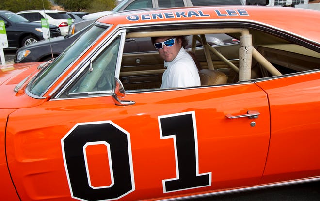In this Feb. 1, 2012, file photo, golfer Bubba Watson drives off in the General Lee after playing in the pro-am at the Phoenix Open golf tournament in Scottsdale, Ariz. Bubba Watson says he's painting over the Confederate flag on his car made popular in "The Dukes of Hazzard" television series. Watson said Friday, July 3, 2015, he'll replace it with the U.S. flag on the roof of the "General Lee 01." (AP Photo/The Arizona Republic, Rob Schumacher, File)