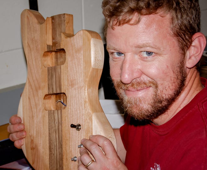 Brian Duffy, a shop teacher from Calais, Maine, shows off his guitar body after fitting the jack on June 25 at Noble High School in North Berwick, Maine. Photo by Shawn St.Hilaire/Fosters.com