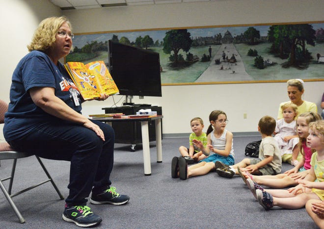 Cindy Moore, of South Hutchinson, reads to children who gathered for storytime at the Hutchinson Public Library.