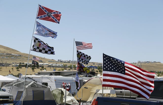 A number of flags, including a Confederate themed one, fly atop RV's in a campground outside the track during practice for the NASCAR Sprint Cup Series auto race Friday Jun. 26 in Sonoma, Calif. (AP Photo/Eric Risberg)
