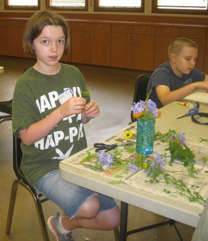 Caeli Benyacko with her brother Andrew Benyacko learn flower arranging at Flora and Fauna day camp.