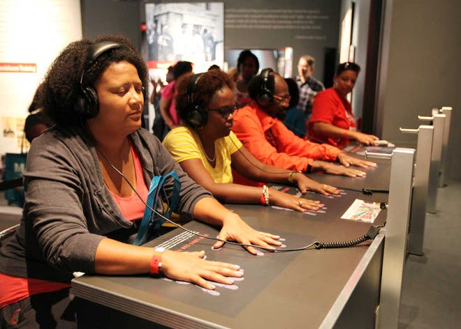 Visitors at Atlanta's Center for Civil and Human Rights experience a simulation of the taunting and aggression faced by civil rights activists during sit-ins. Credit: Studio Fitz.