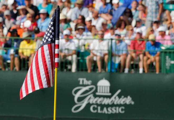 The flag on the 18th hole is replaced by a United States flag during the third round of the Greenbrier Classic golf tournament at Greenbrier Resort in White Sulphur Springs, W.Va., Saturday, July 4, 2015.