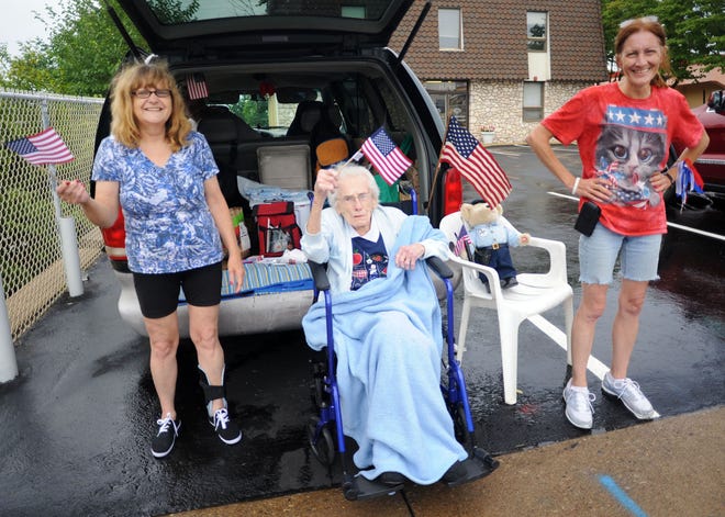 From left, Karen Vonsydow, Cecilia Schilk, 95, and Ceil Dixon wave American flags during the Lower Southampton Independence Day Parade on Saturday, July 4, 2015.
