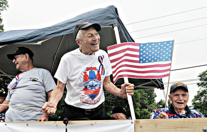 Workd War II veterans engage the crowd during the annual Fourth of July parade in Middletown Saturday, July 4,2015. This year's parade commemorates the 70th anniversary of the end of World War II.