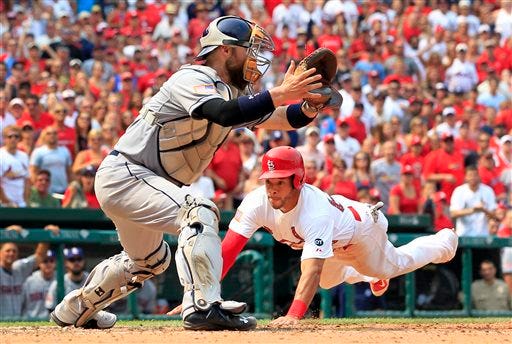 St. Louis Cardinals' Tommy Pham, right, scores past San Diego Padres catcher Derek Norris during the eighth inning of a baseball game Saturday, July 4, 2015, in St. Louis. The Cardinals won 2-1. (AP Photo/Jeff Roberson)