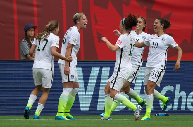 United States' Tobin Heath, Abby Wambach, Lauren Holiday, Christie Rampone and Carli Lloyd, fromleft, celebrate Wambach's goal against Nigeria during the first half of a FIFA Women's World Cup soccer game in Vancouver, British Columbia, Canada. (Darryl Dyck/The Canadian Press via AP)