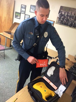 Palmyra Police Patrolman Scott Snow handles a kit containing the anti-opioid medication Narcan.