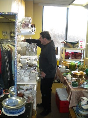 Courtesy photo

A volunteer sorts items at a nonprofit thrift shop, the proceeds of which supports local housing programs.