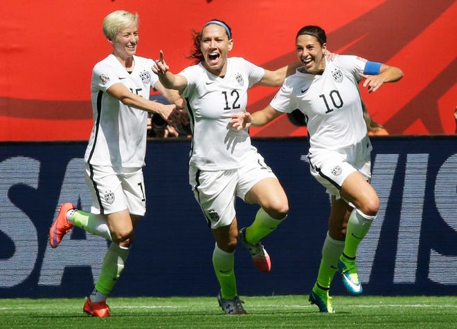 From left, United States' Megan Rapinoe, Lauren Holiday and Carli Lloyd celebrate after Lloyd scored her second goal of the match against Japan during the first half of the FIFA Women's World Cup soccer championship in Vancouver, British Columbia, Canada, today. The U.S. leads 4-1 at the half. AP Photo/Elaine Thompson
