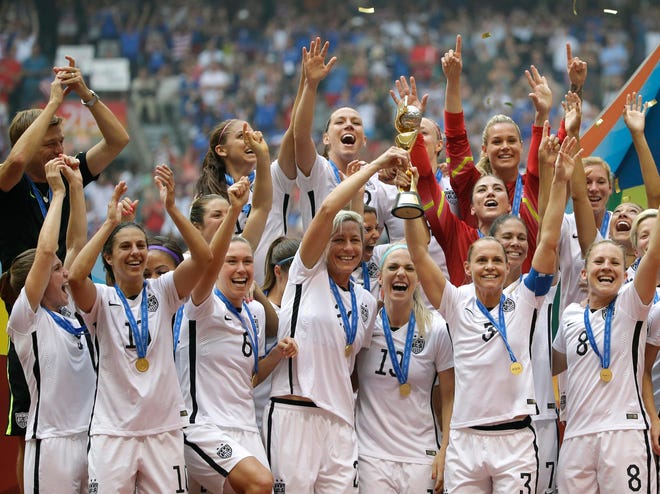 United States players celebrate with the trophy after they beat Japan, 5-2, in the FIFA Women's World Cup soccer championship in Vancouver, British Columbia, Canada, Sunday. Photo by AP