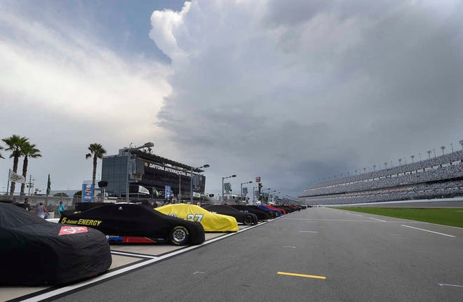 Cars line pit road during a weather delay before NASCAR qualifying at Daytona International Speedway, Saturday, July 4, 2015, in Daytona Beach, Fla. (AP Photo/Phelan M. Ebenhack)