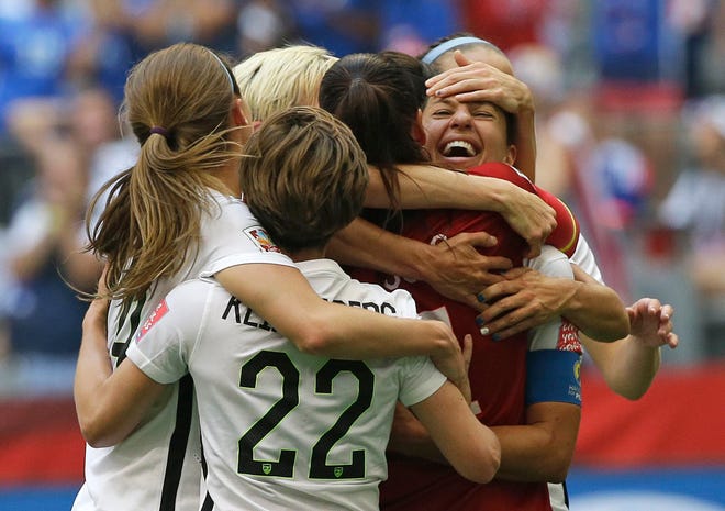 The United States' Carli Lloyd, right, celebrates with teammates after Lloyd scored her third goal against Japan during the first half of the FIFA Women's World Cup soccer championship in Vancouver, British Columbia, Canada, Sunday, July 5, 2015. THE ASSOCIATED PRESS