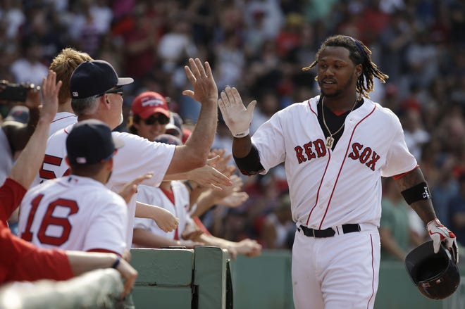 Boston's Hanley Ramirez is welcomed to the dugout after hitting a two-run homer in the seventh inning. THE ASSOCIATED PRESS